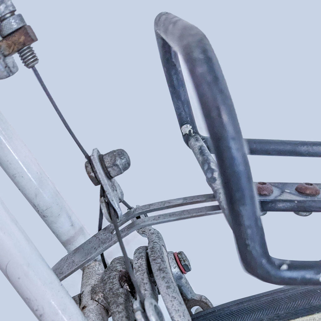 Close-up of a pre-owned Reperch road bicycle's rear brake system showing signs of wear and use.