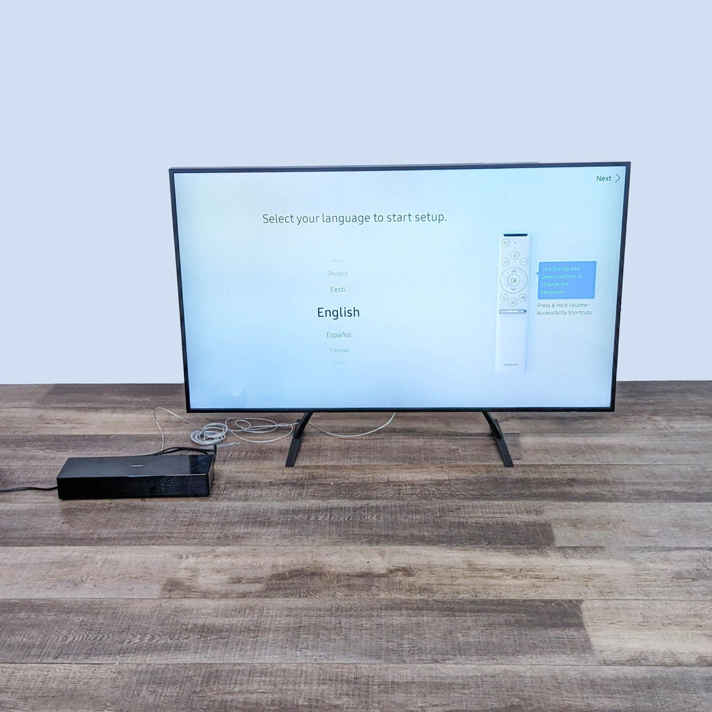 Samsung TV setup screen with language selection and connected cables.