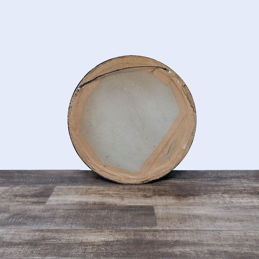 3. Back view of a round Reperch mirror, displaying the mounting hardware and backing materials.