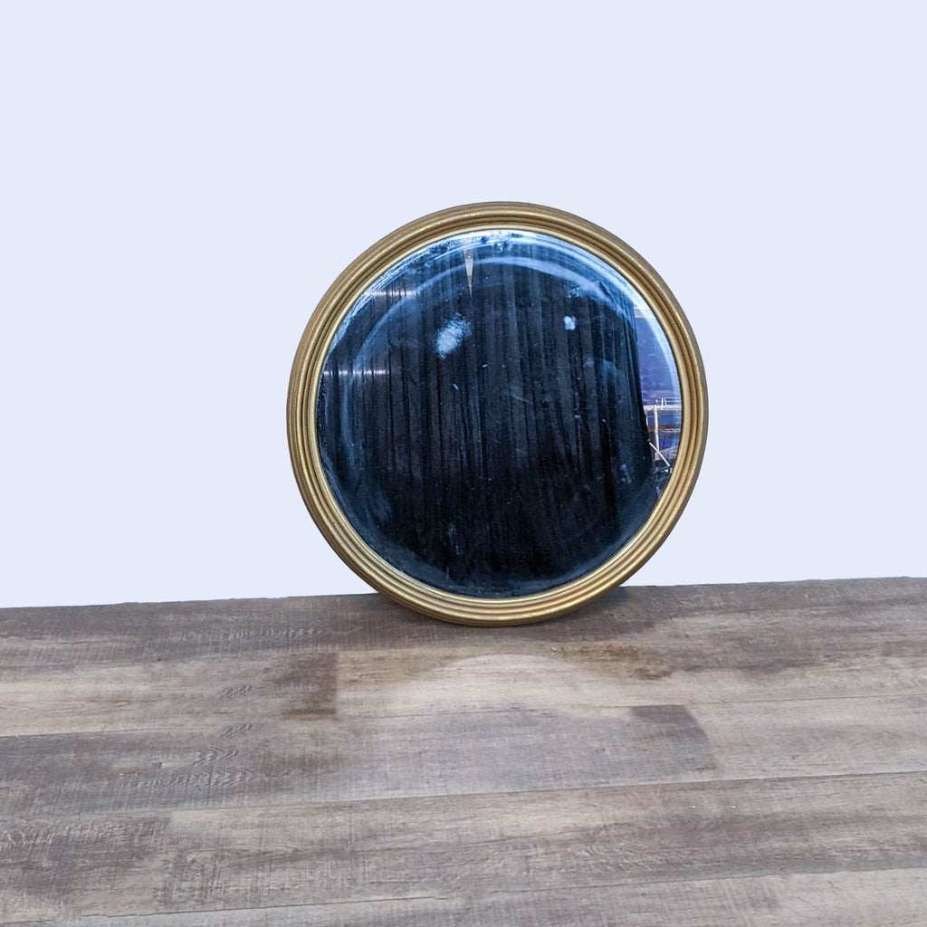 1. Front view of a Reperch round wall mirror with a gold wood frame, about 35 inches in diameter.  