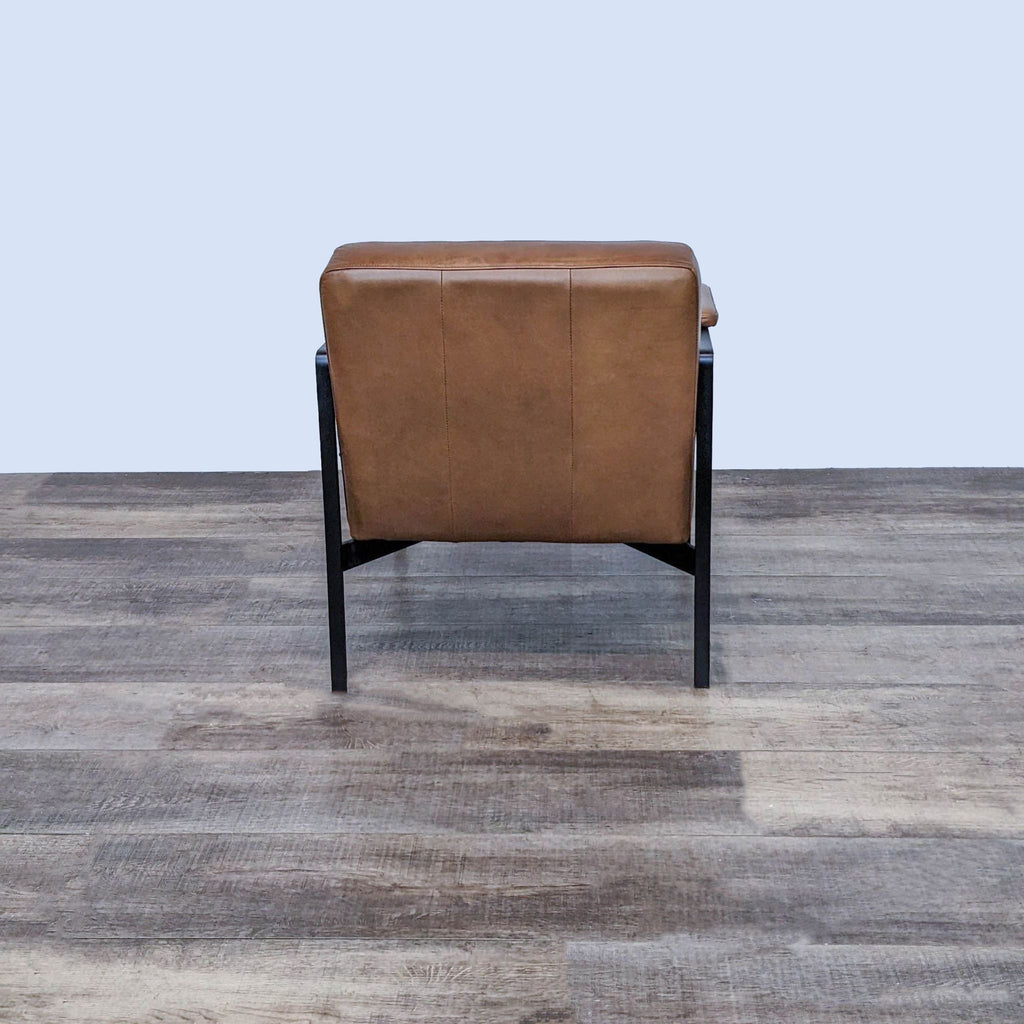 Rear view of the West Elm Highline chair highlighting its leather backrest.