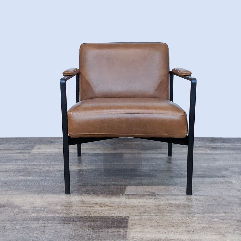 Front view of the Highline chair by West Elm, with leather seat and steel frame.