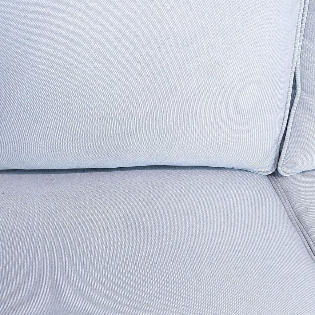 Close-up of a gray Reperch 3-seat sofa with narrow arms and wood-finish feet.