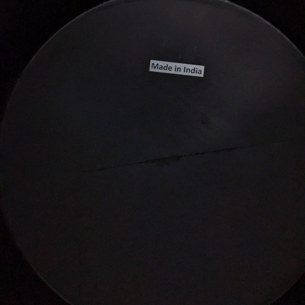 Bottom view of Reperch drum table with "Made in India" label.