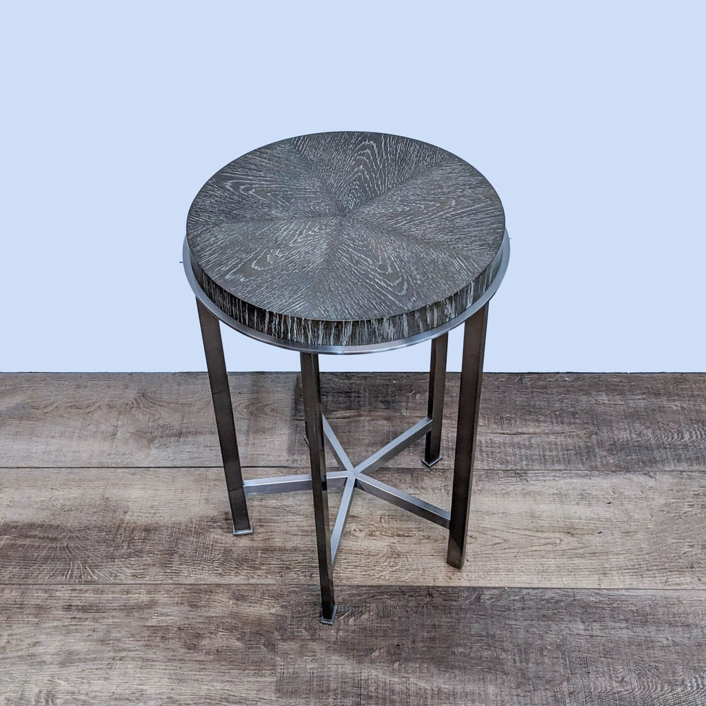 Alt text 2: A Bassett Furniture metal and wood side table featuring a circular top with starburst woodgrain design, on a robust frame.