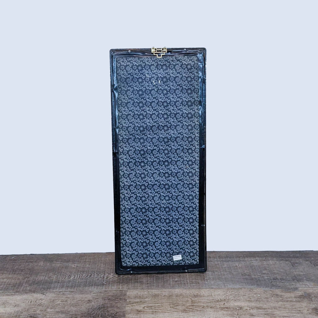 Tall floral-patterned Reperch vase case on a wooden surface against a plain background.