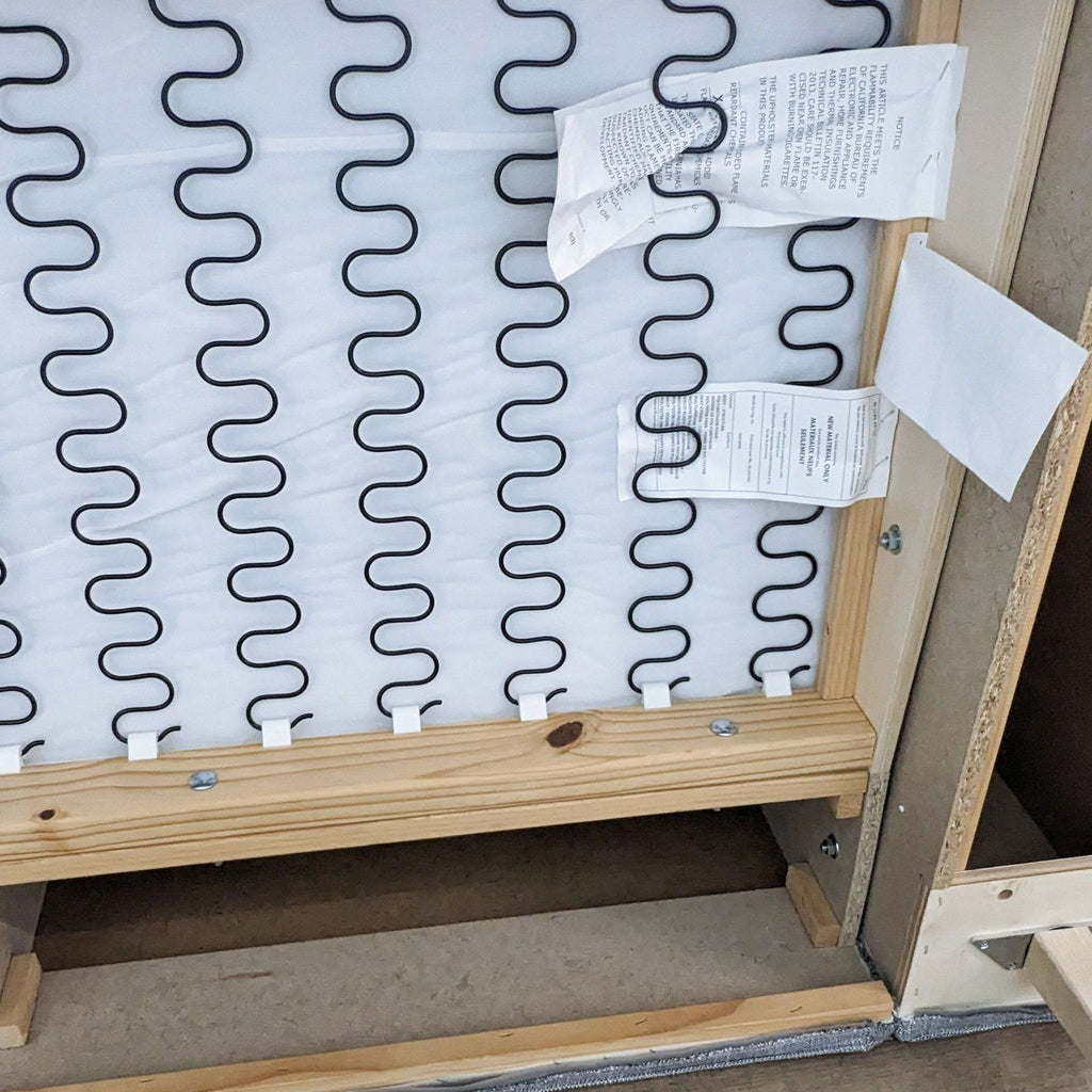 Underside view of the sofa frame and spring system.