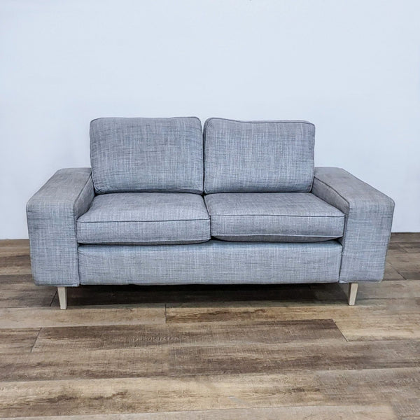 Gray IKEA 3-seat sofa with square arms and light finish feet.