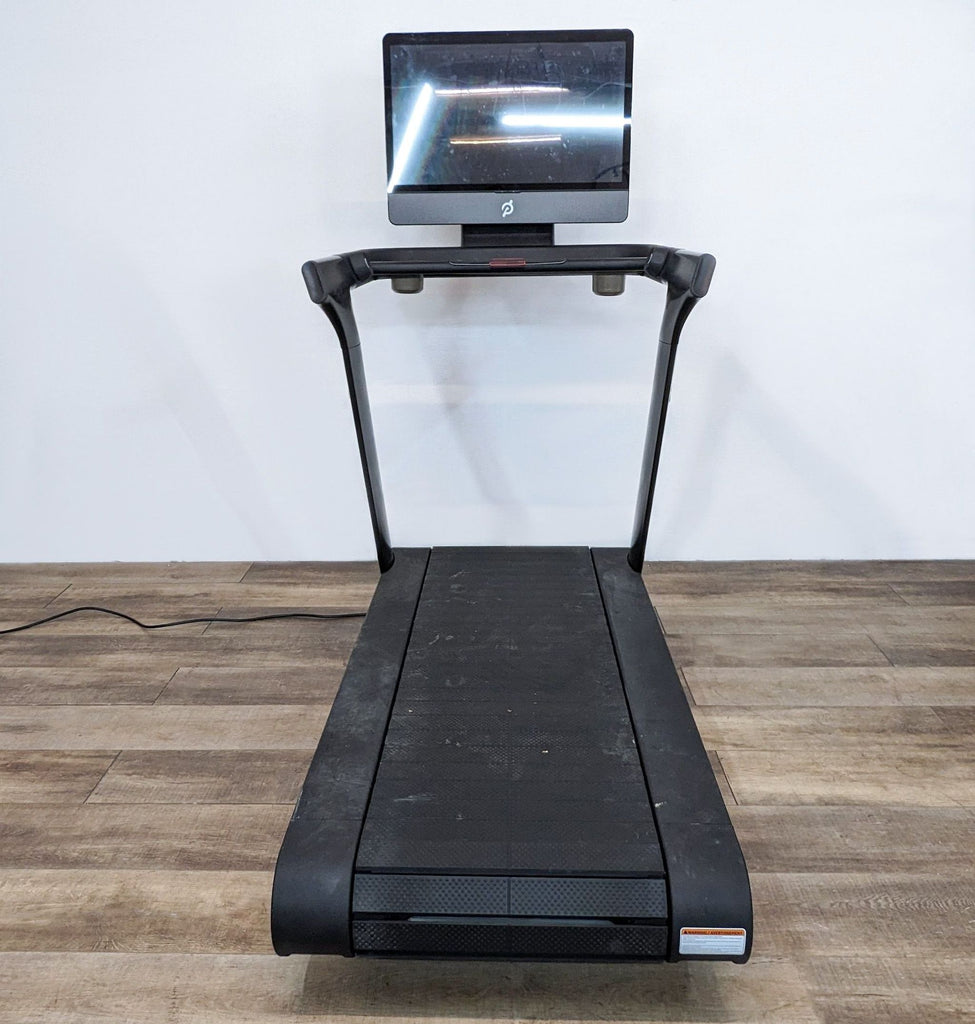 Peloton treadmill with interactive display for live workouts and classes at home.
