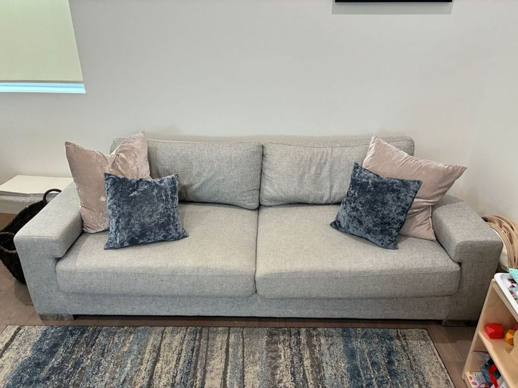 Gently used Ben Soleimani sofa, three seats, soft cushions, and a minimalist square-arm design in light gray.