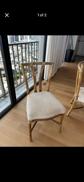 1. McGuire dining chair with curved rattan frame and light cushioned seat, ideal for elegant dining settings.  