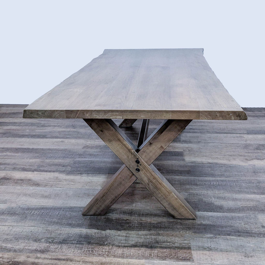 Alt text 2: Overhead view of Bassett's Benchmade Crossbuck maple dining table, highlighting the distinctive live edge and exposed joinery.