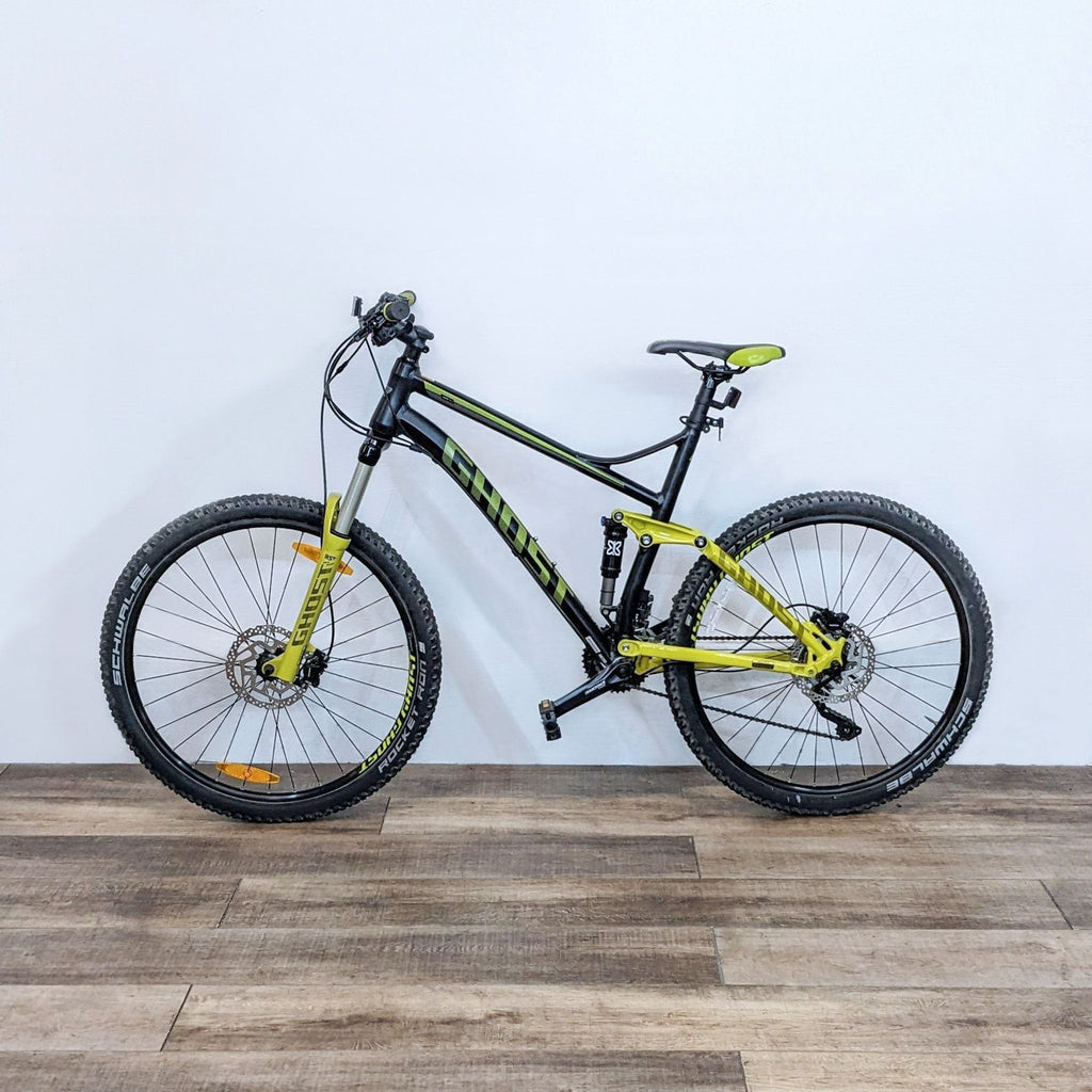 Mountain bike with a full suspension in yellow and black, designed for off-road adventures.