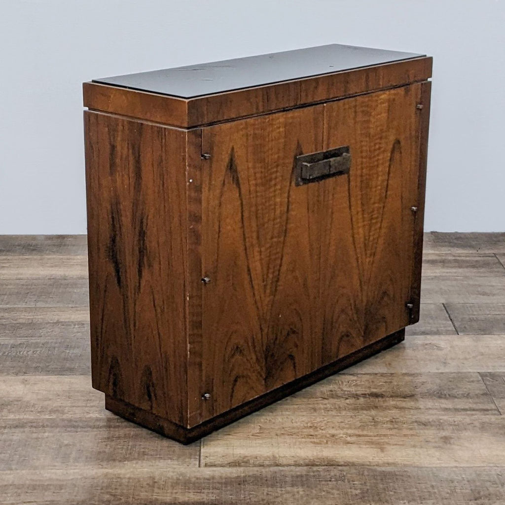 a mid century modern, solid wood storage chest with a metal handle.