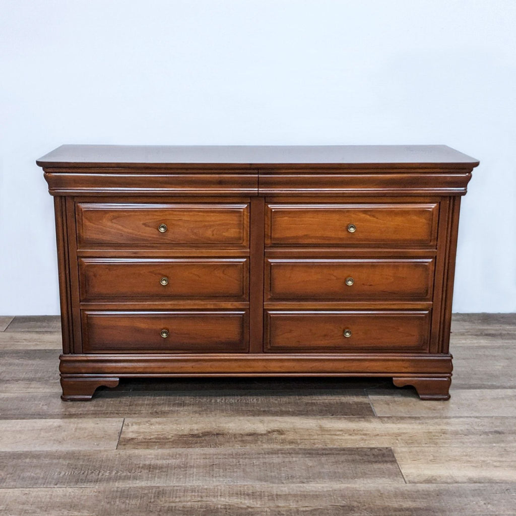 Traditional Reperch dresser with 8 drawers and antique brass knobs.