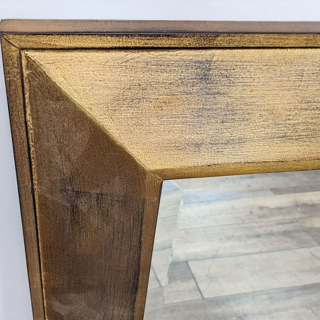 Close-up of Reperch gold-finished wood frame corner, showing beveled mirror and textured frame details.