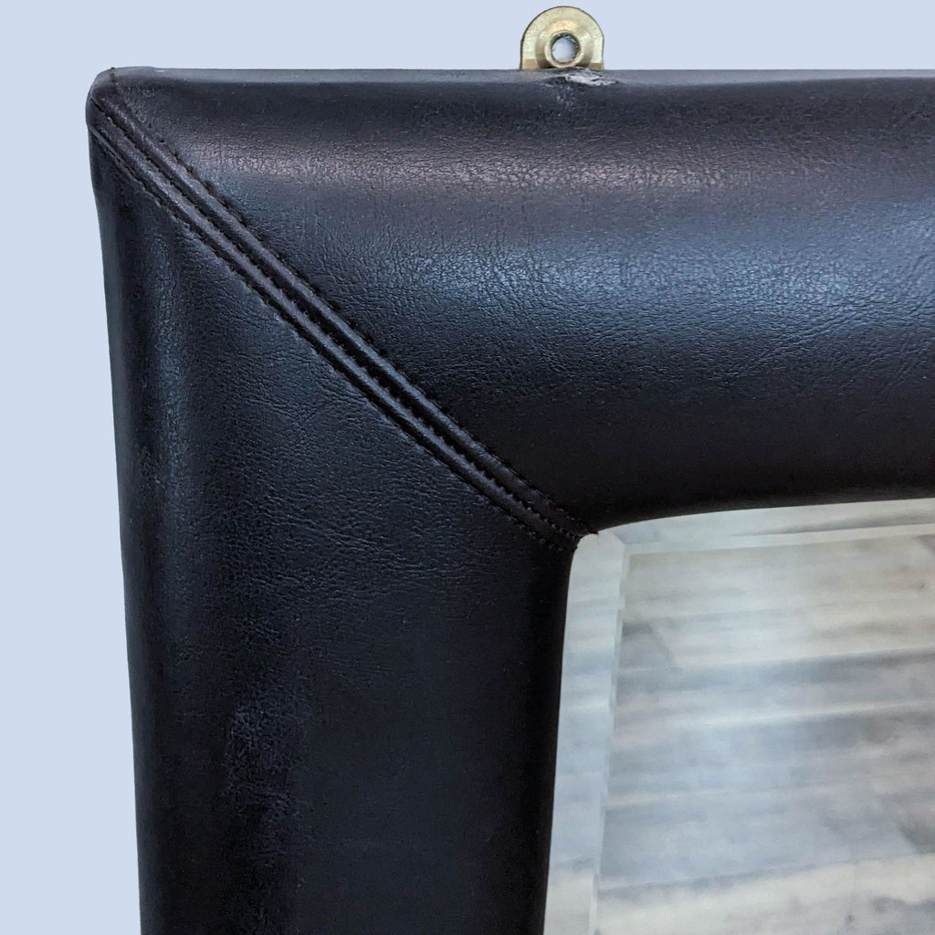 Close-up of black faux leather frame detail on Reperch mirror.
