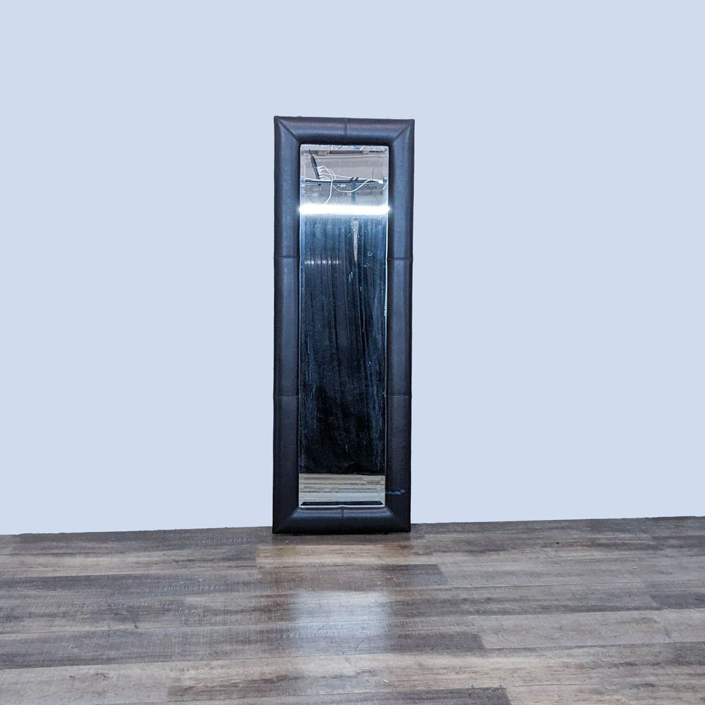 Full-length mirror with black faux leather frame, by Reperch.