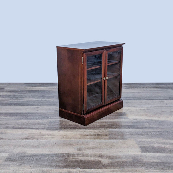 Bombay Company bookshelf with glass doors and adjustable shelves on a wooden floor.