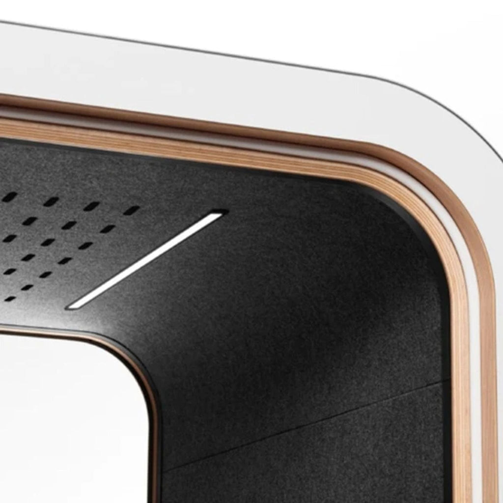 Close-up of the booth's interior, highlighting the stylish black lining and built-in lighting for optimal focus.