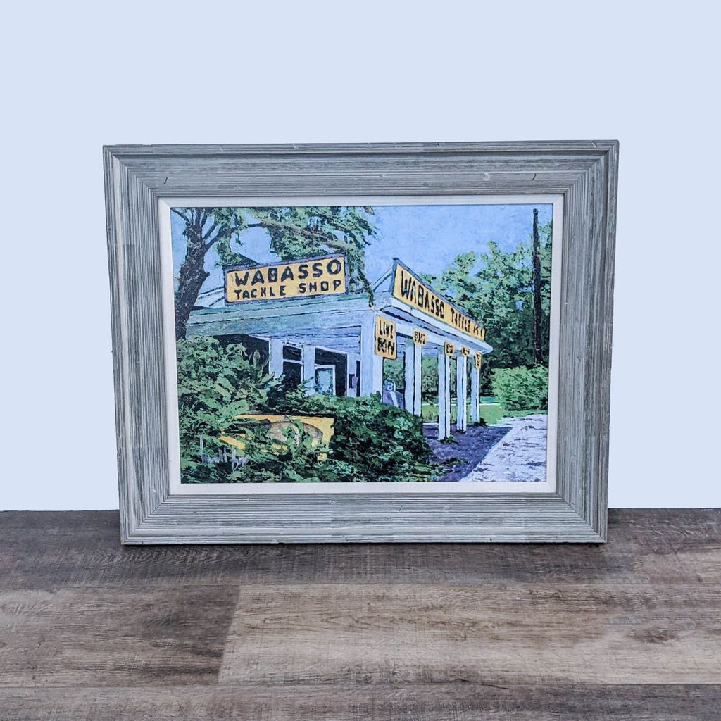 Framed painting of Wabasso Tackle Shop, surrounded by greenery and clear skies.