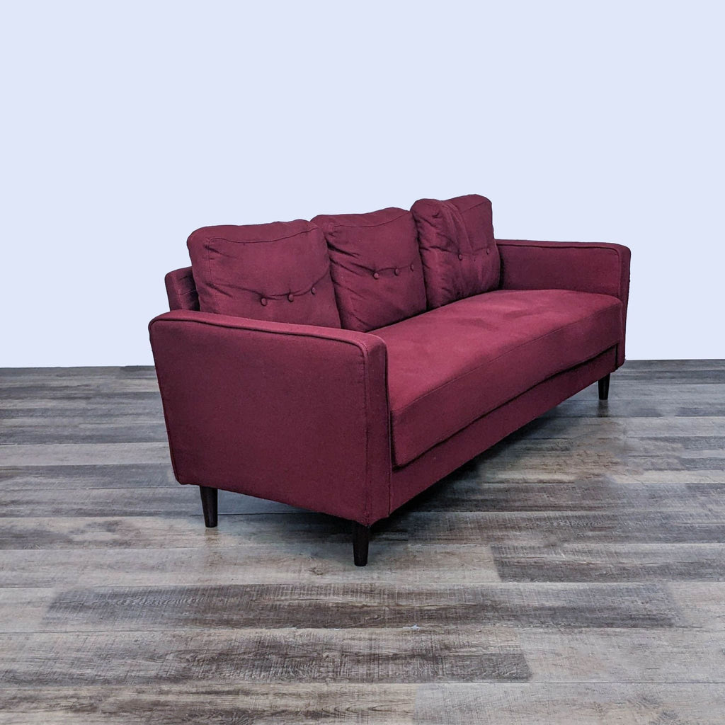 Angled side view of a Zinus burgundy button-back 3-seater sofa, featuring slim arms and wood feet.  