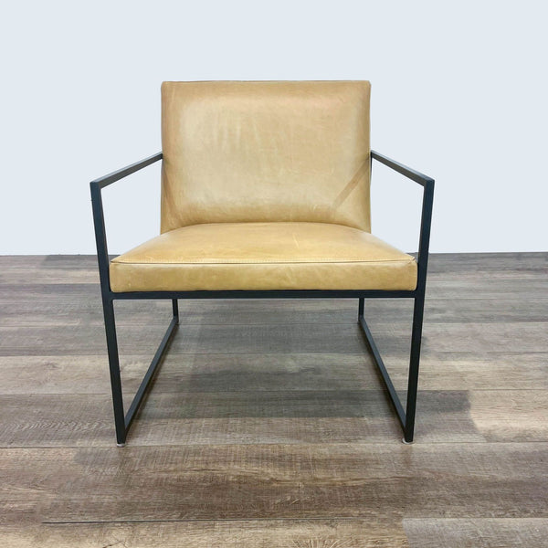 Room & Board Novato armchair with a minimalist natural steel frame and a floating tan leather seat.