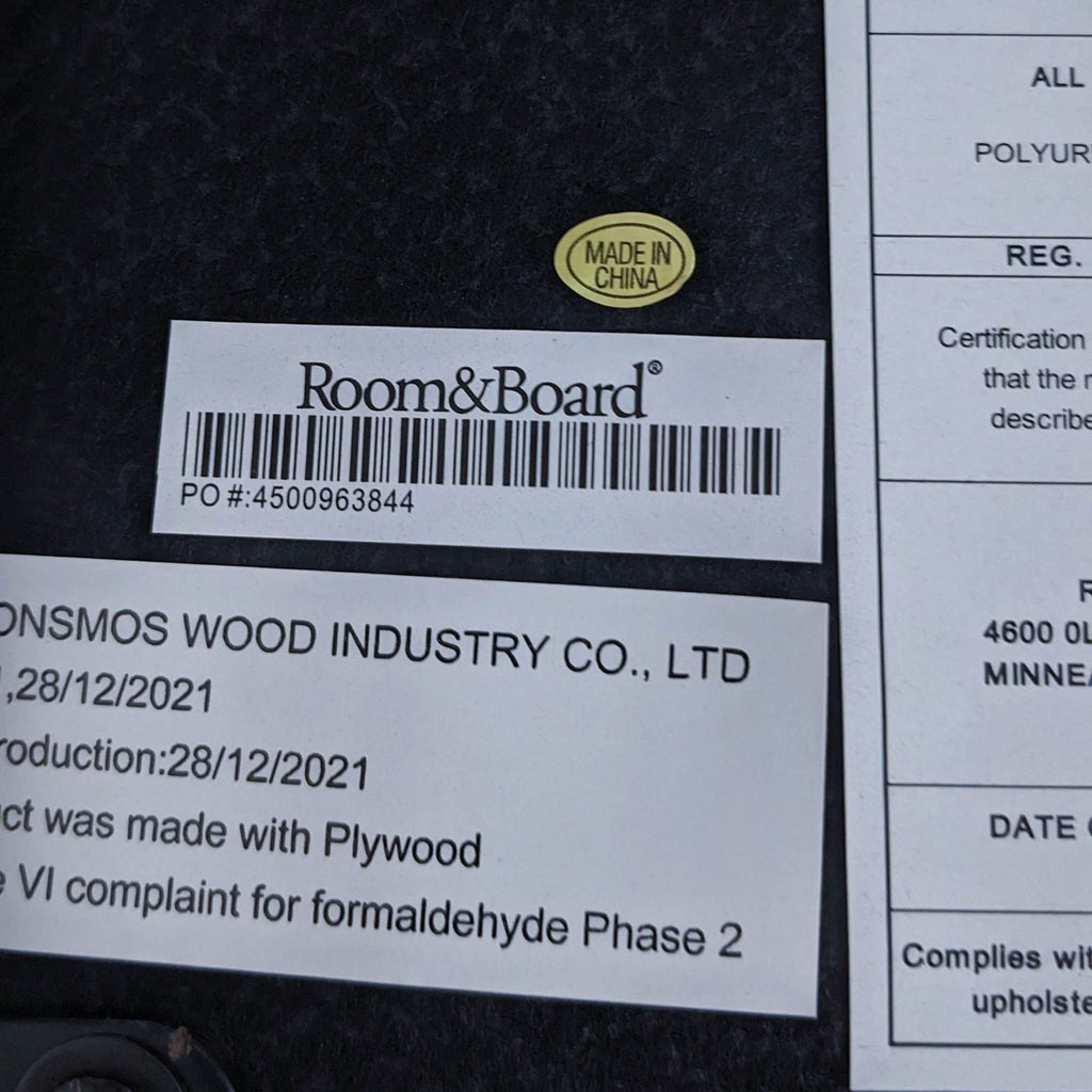 Alt text: Label from Room & Board indicating manufacturing details of a minimalist leather-look counter stool.