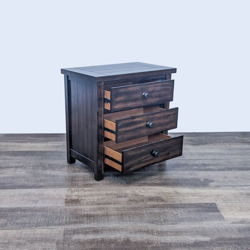 Alt text 2: Dark brown Reperch wooden end table with visible planks and knobs, partially open drawer showing items, on a laminate surface.