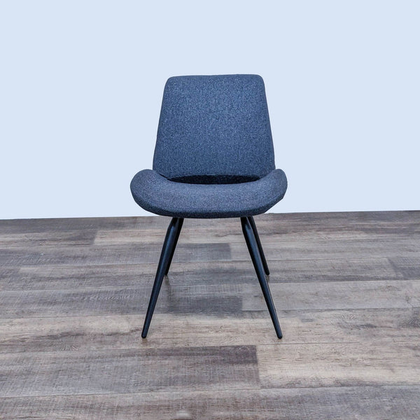 Front view of a mid-century modern dining chair with tapered legs.