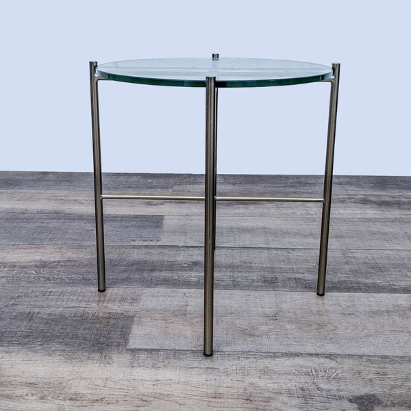 Sleek Reperch end table with a round glass top and metal legs.