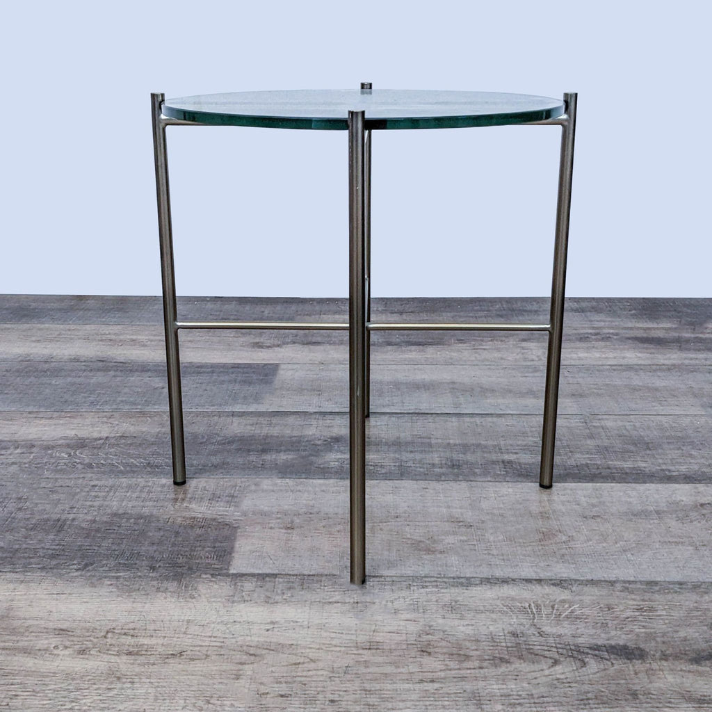 Modern end table by Reperch featuring a glass top and sturdy metal base.