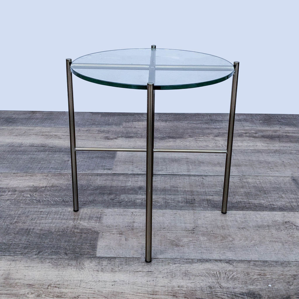 Round glass-topped Reperch end table with minimalist metal frame.