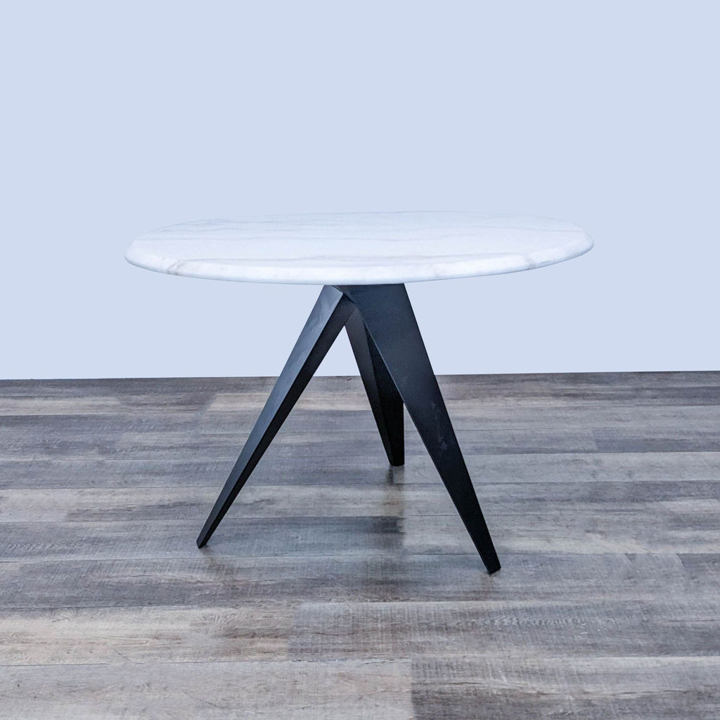 Reperch dining table showcasing a beveled marble top and coated steel base, perfect for modern spaces.