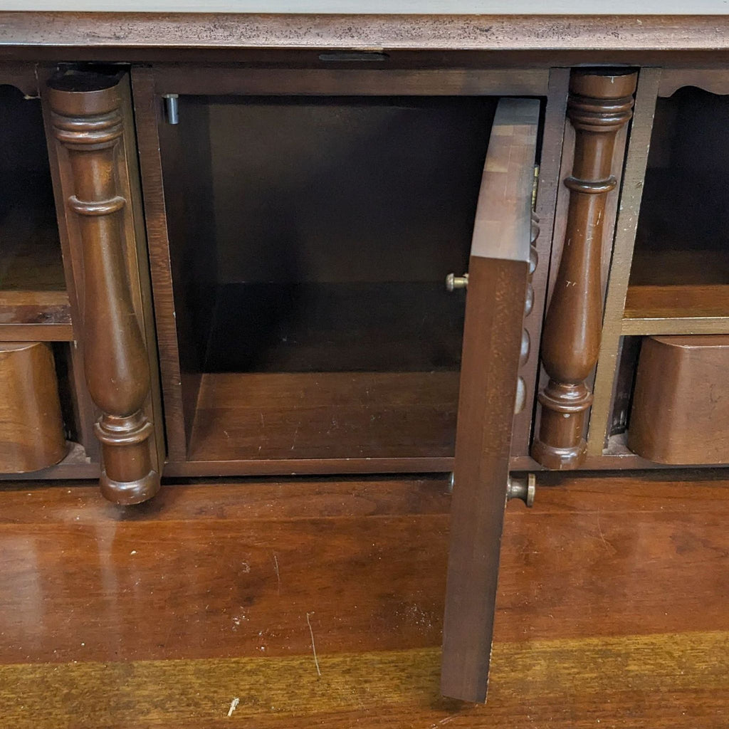 Interior view of desk showcasing open cubbyhole compartment with decorative columns.