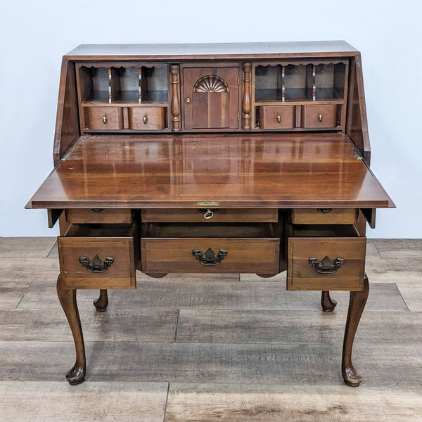 Compact desk with drop-front, six drawers, and shelves for ample storage.