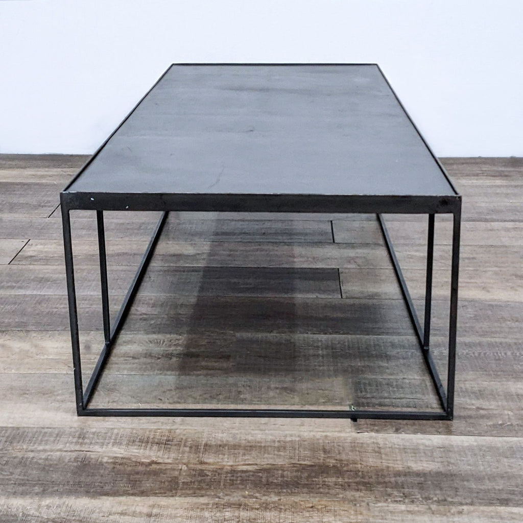 Reperch brand coffee table with a minimalist black metal frame and a rectangular smoked glass top.