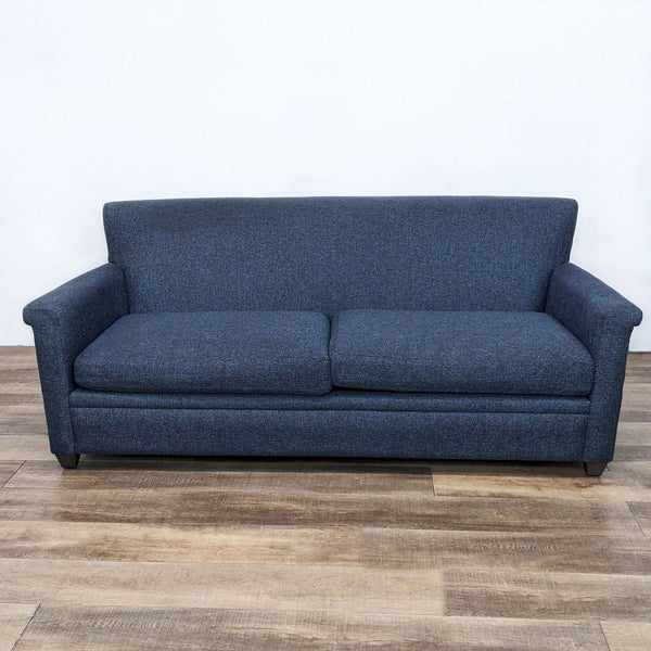 Dark blue loveseat with straight back and turned arms, featuring a dark finish on its feet.