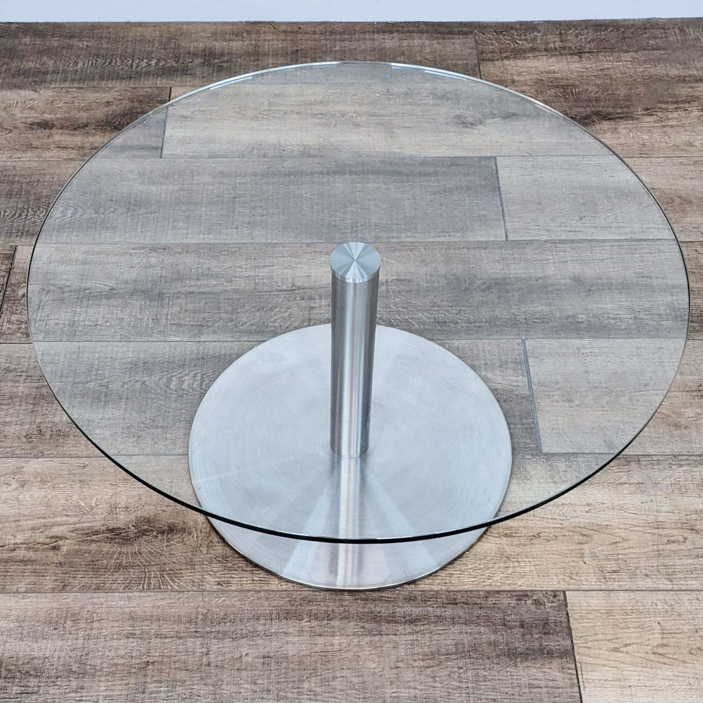 Overhead view of Reperch round glass end table showing clear surface and sturdy metal stand.