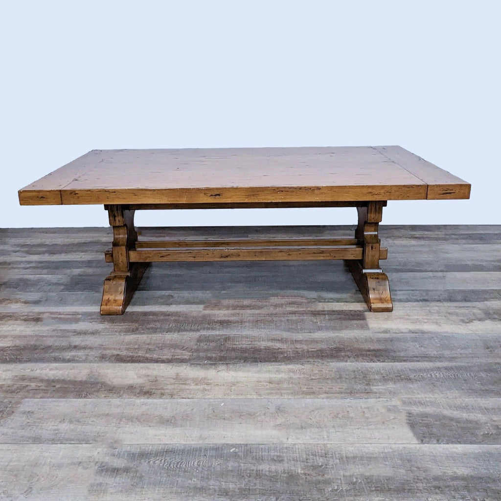 Walter of Wabash trestle base, rectangular, wooden dining table from a 9-piece dining set on a wooden floor.
