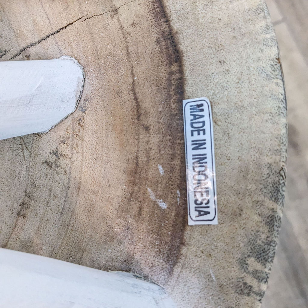 Close-up of Reperch table top showing wood grain and "made in Indonesia" sticker.