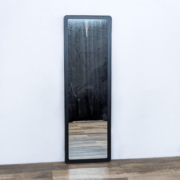 a large mirror with a black frame.