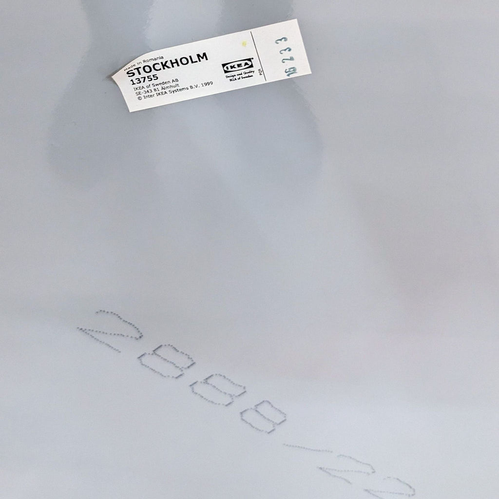 Close-up of IKEA label on the Stockholm mirror, with product information and numbers.