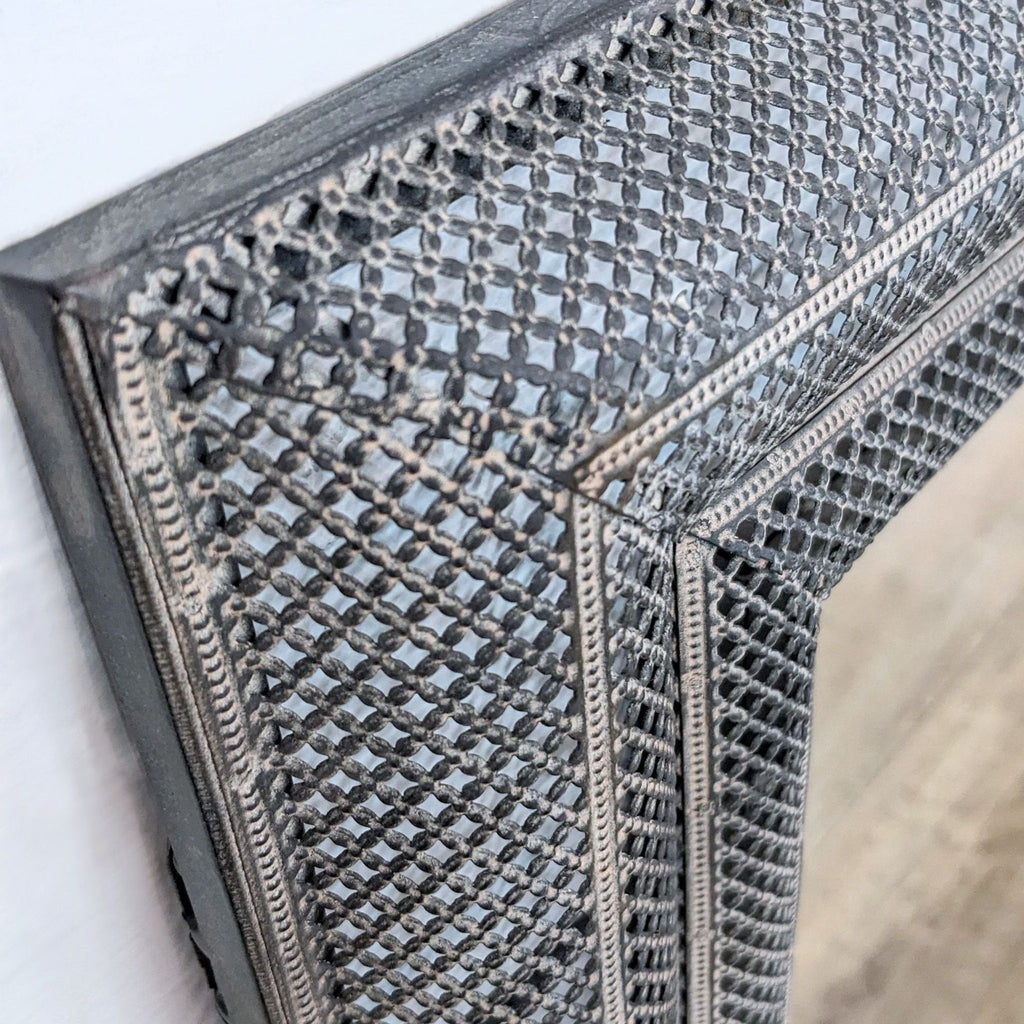 Textured frame detail of the stylish Uttermost mirror in focus.