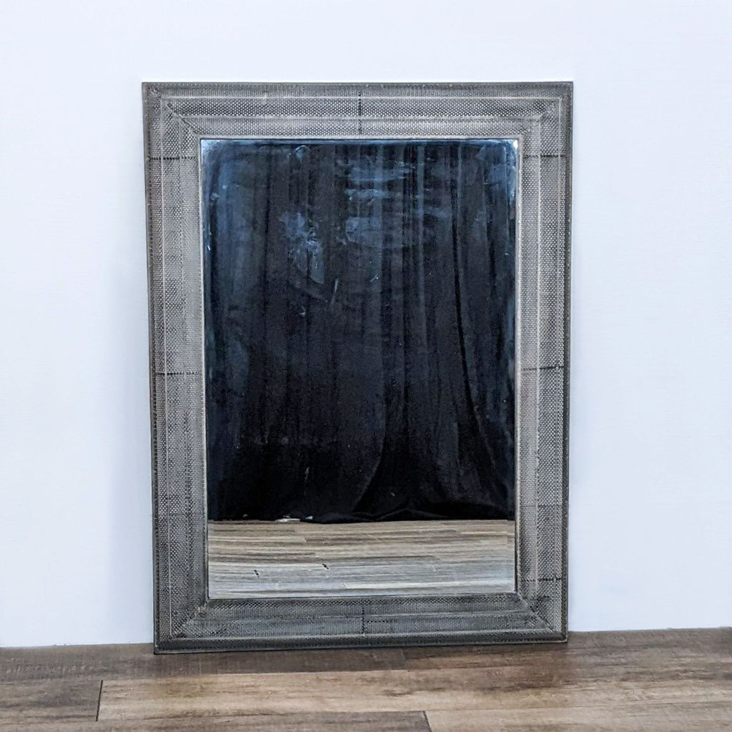 Uttermost mirror with a textured frame enhancing a room's elegance.