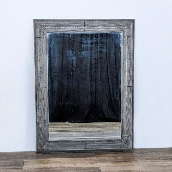 Uttermost mirror with a textured frame enhancing a room's elegance.