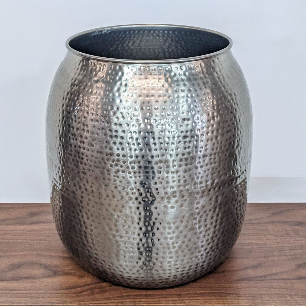 Nickel-finished side table with hand-hammered texture, offering storage beneath the removable lid.