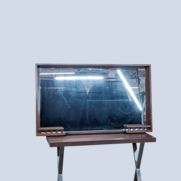 the mirror is a vintage piece of furniture that is made of wood and has a metal frame.