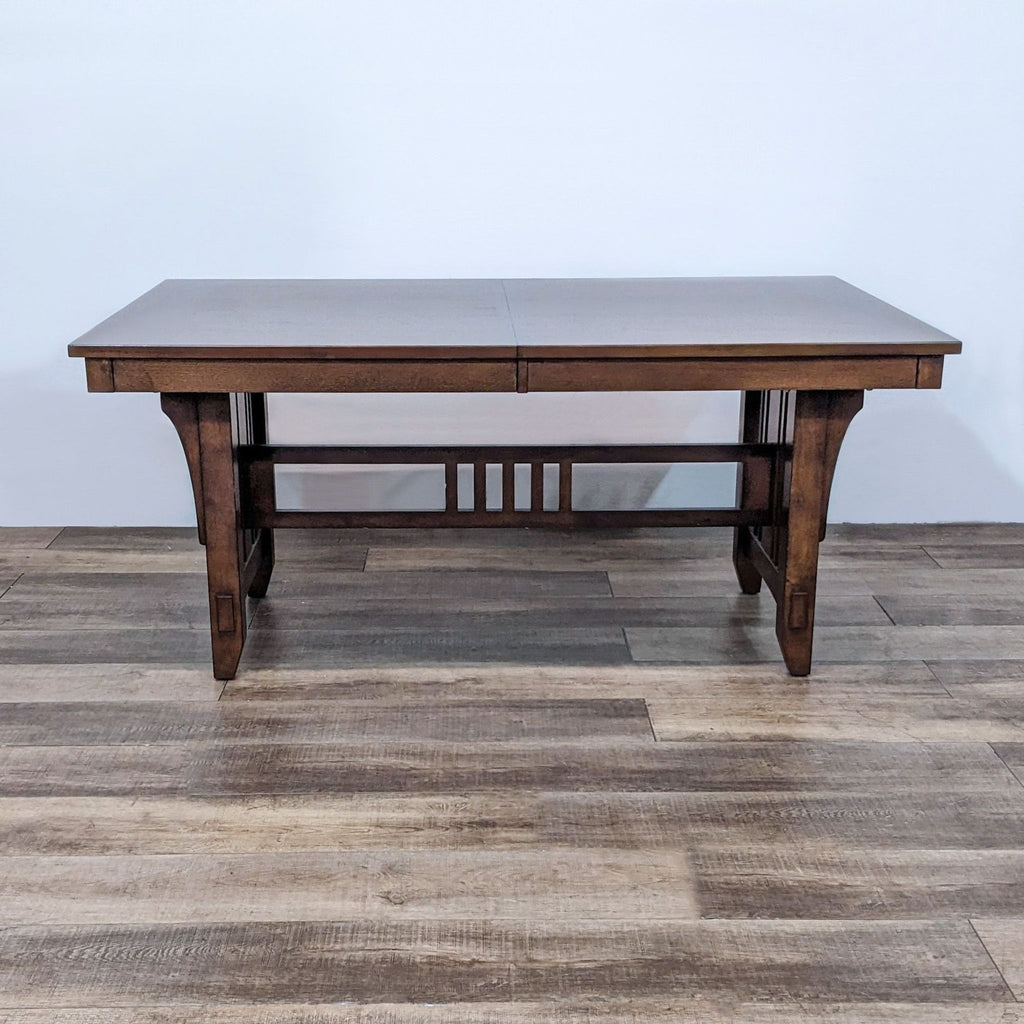 Wooden dining table with bow tie inlays, two expansion leafs, and sturdy design.