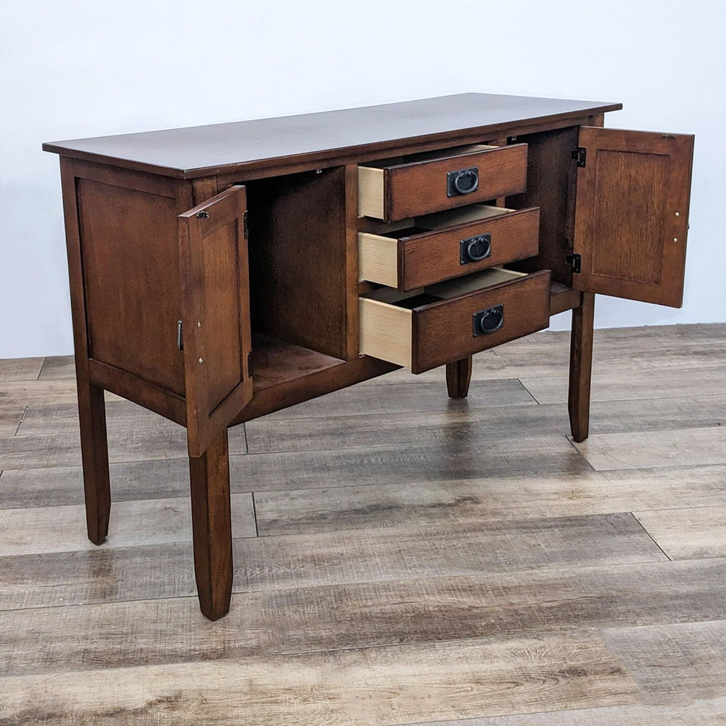 Sideboard showing open cabinet doors and drawers, highlighting interior storage space. 